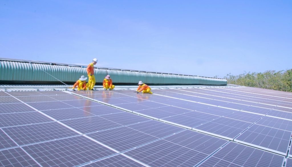 men putting in solar panels